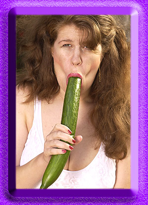 Dixie sucking on a long cucumber